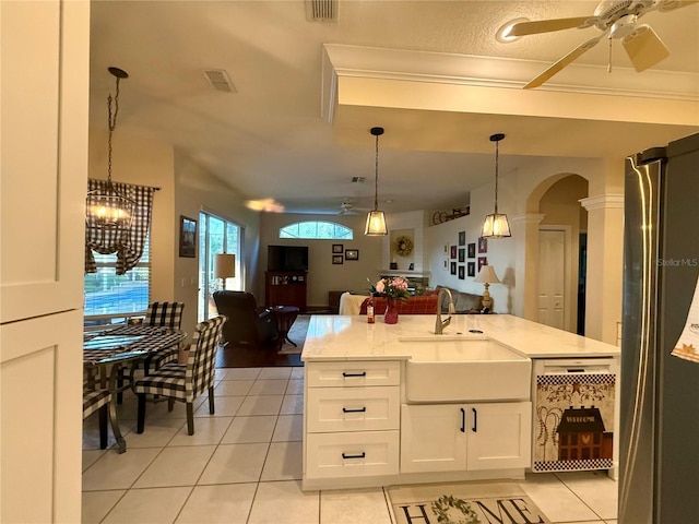 13133 Roseanna Dr, Spring Hill, FL 34609 - kitchen with freestanding refrigerator, a sink, ceiling fan, dishwashing machine, and arched walkways