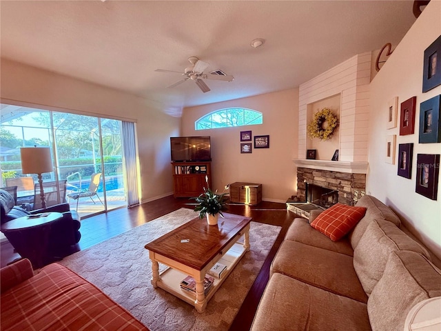 13133 Roseanna Dr, Spring Hill, FL 34609 - living room featuring plenty of natural light, a ceiling fan, a stone fireplace, and wood finished floors