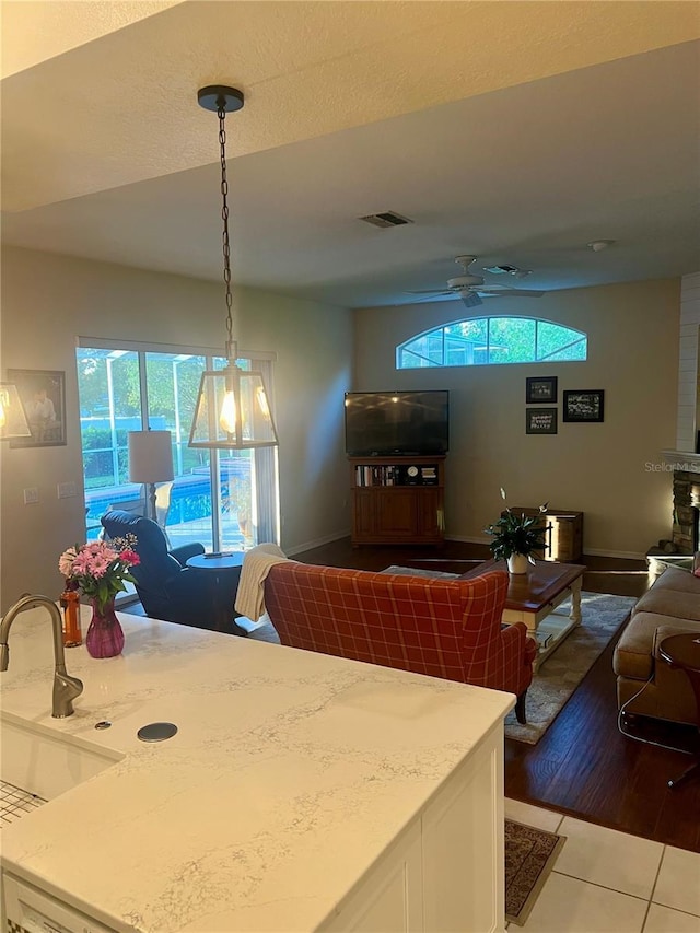 13133 Roseanna Dr, Spring Hill, FL 34609 - dining room with healthy amount of natural light, a ceiling fan, dark tile patterned floors, and baseboards