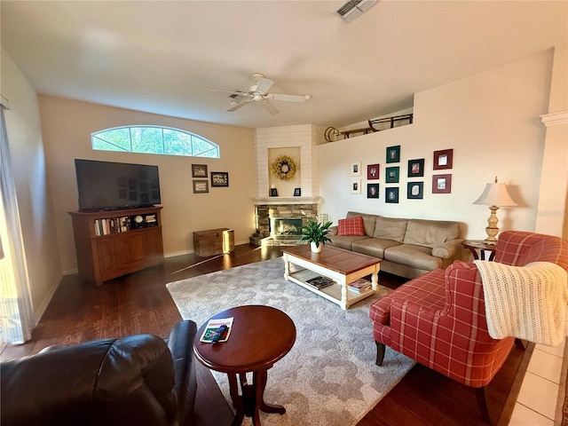 13133 Roseanna Dr, Spring Hill, FL 34609 - living area featuring a ceiling fan, wood finished floors, a stone fireplace, and baseboards