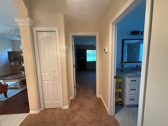 13133 Roseanna Dr, Spring Hill, FL 34609 - hall with carpet, baseboards, and a sink