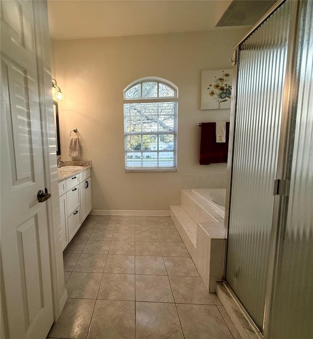 13133 Roseanna Dr, Spring Hill, FL 34609 - bathroom with vanity, a garden tub, an enclosed shower, baseboards, and tile patterned floors