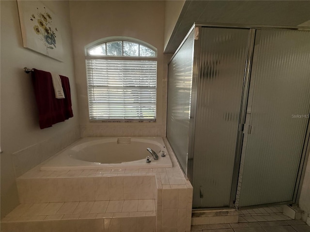 13133 Roseanna Dr, Spring Hill, FL 34609 - bathroom featuring a garden tub, a shower stall, and tile patterned flooring