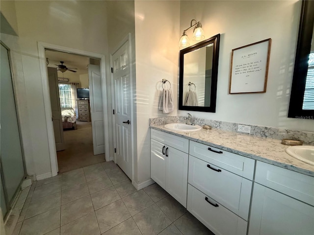13133 Roseanna Dr, Spring Hill, FL 34609 - ensuite bathroom featuring double vanity, ceiling fan, tile patterned flooring, and baseboards