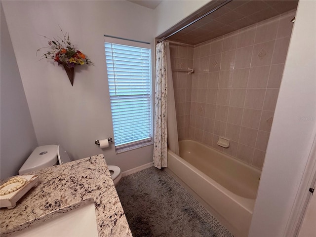 13133 Roseanna Dr, Spring Hill, FL 34609 - full bath with toilet, baseboards, vanity, and shower / bath combo with shower curtain