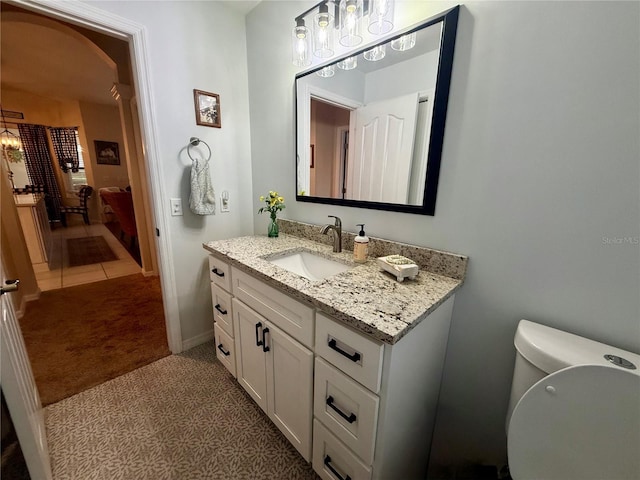 13133 Roseanna Dr, Spring Hill, FL 34609 - bathroom featuring vanity, toilet, and baseboards