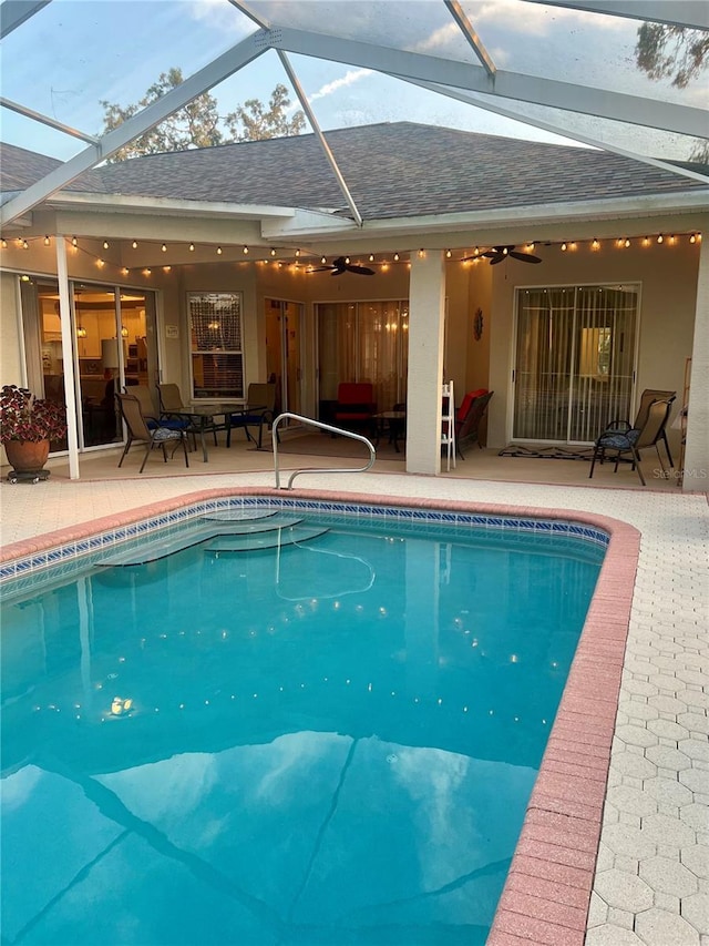 13133 Roseanna Dr, Spring Hill, FL 34609 - outdoor pool with ceiling fan, a patio area, glass enclosure, and an outdoor hangout area