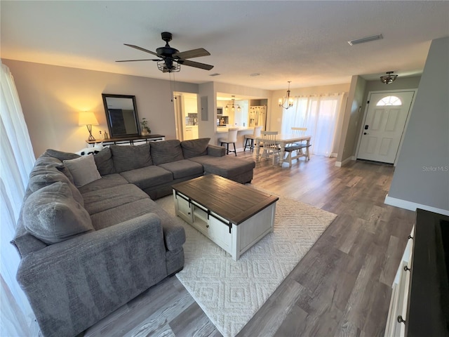 30 Tads Trl, Oldsmar, FL 34677 - living area featuring ceiling fan, wood finished floors, baseboards, and a chandelier