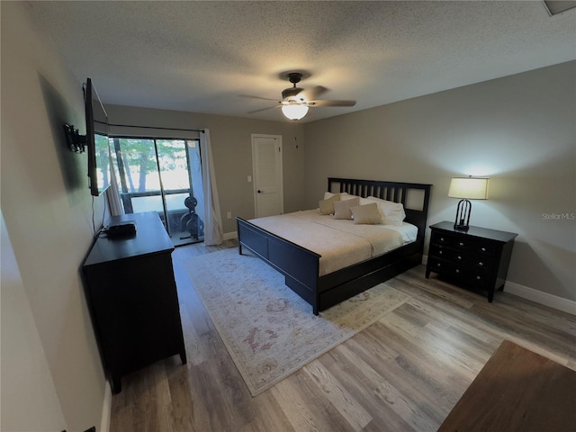 30 Tads Trl, Oldsmar, FL 34677 - bedroom featuring access to exterior, a textured ceiling, wood finished floors, baseboards, and a ceiling fan