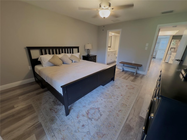 30 Tads Trl, Oldsmar, FL 34677 - bedroom featuring light wood-type flooring, baseboards, a ceiling fan, and ensuite bath