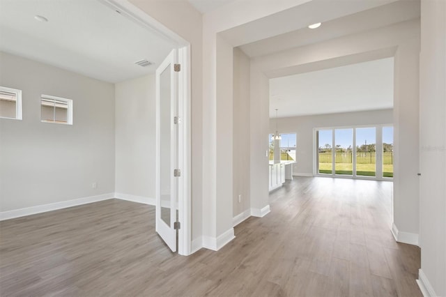 10320 Longmeadow Ave, Parrish, FL 34219 - hall with wood finished floors and baseboards