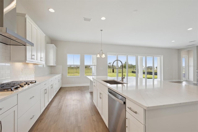 10320 Longmeadow Ave, Parrish, FL 34219 - kitchen with appliances with stainless steel finishes, wall chimney range hood, a sink, recessed lighting, and tasteful backsplash