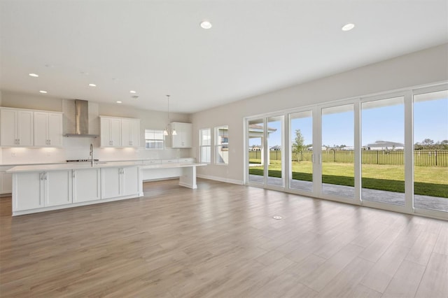 10320 Longmeadow Ave, Parrish, FL 34219 - unfurnished living room featuring a sink, light wood finished floors, recessed lighting, and baseboards