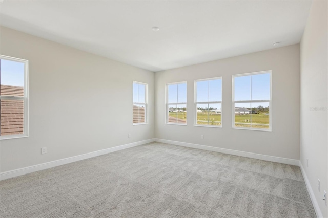 10320 Longmeadow Ave, Parrish, FL 34219 - empty room with healthy amount of natural light, light carpet, and baseboards