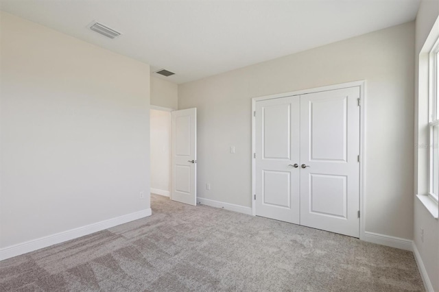 10320 Longmeadow Ave, Parrish, FL 34219 - unfurnished bedroom featuring carpet, a closet, and baseboards