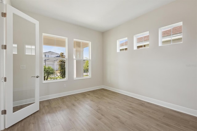 10320 Longmeadow Ave, Parrish, FL 34219 - spare room featuring wood finished floors and baseboards