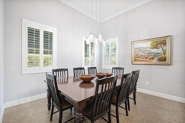 610 Winterside Dr, Apollo Beach, FL 33572 - dining space featuring baseboards, tile patterned floors, crown molding, a high ceiling, and a chandelier