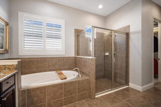 610 Winterside Dr, Apollo Beach, FL 33572 - full bathroom featuring a garden tub, a shower stall, tile patterned flooring, and vanity