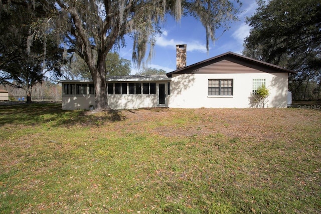 3705 Bruton, Plant City, FL 33565 - rear view of property with a chimney, a sunroom, and a yard