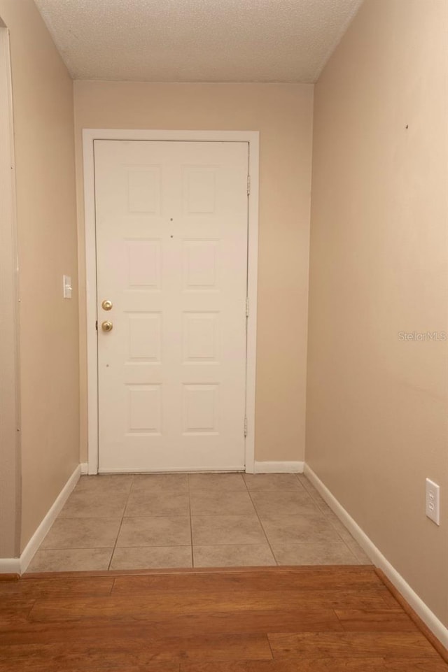 3705 Bruton, Plant City, FL 33565 - doorway to outside with baseboards, light tile patterned flooring, and a textured ceiling