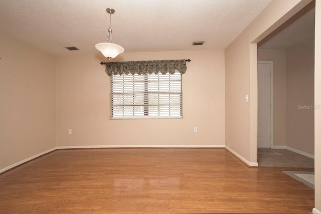 3705 Bruton, Plant City, FL 33565 - unfurnished room with light wood-style floors, a textured ceiling, and baseboards