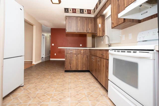 3705 Bruton, Plant City, FL 33565 - kitchen featuring white appliances, under cabinet range hood, brown cabinetry, light countertops, and a sink