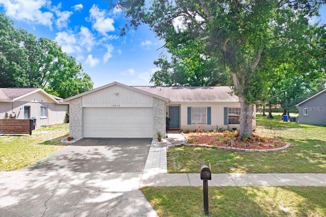 12910 Leadwood Dr, Riverview, FL 33579 - single story home featuring an attached garage, asphalt driveway, a front yard, and stone siding