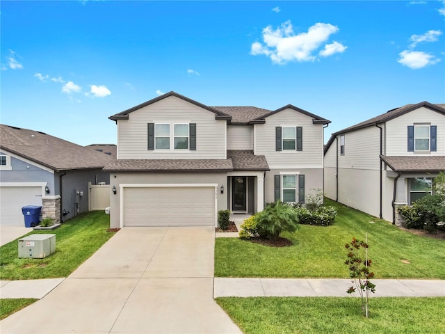 9293 Rally Spring Loop, Wesley Chapel, FL 33545 - traditional home featuring a shingled roof, driveway, an attached garage, a front lawn, and stucco siding