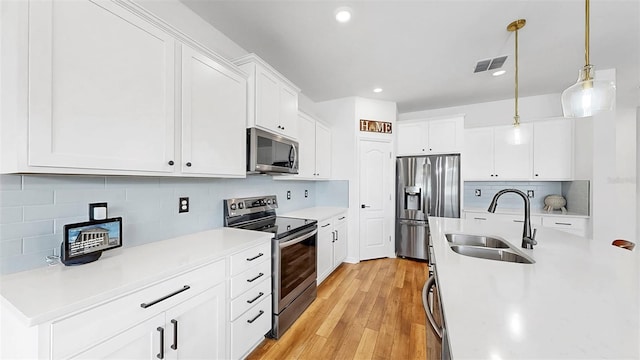 9293 Rally Spring Loop, Wesley Chapel, FL 33545 - kitchen featuring stainless steel appliances, a sink, decorative backsplash, light countertops, and pendant lighting