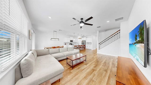 9293 Rally Spring Loop, Wesley Chapel, FL 33545 - living area featuring a ceiling fan, light wood-style floors, recessed lighting, and stairway