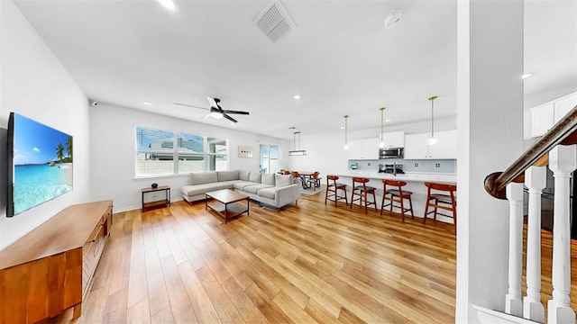 9293 Rally Spring Loop, Wesley Chapel, FL 33545 - living area with a ceiling fan, light wood-type flooring, recessed lighting, and baseboards