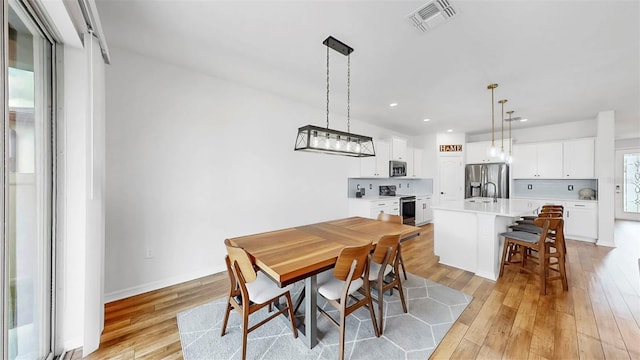 9293 Rally Spring Loop, Wesley Chapel, FL 33545 - dining space with light wood-style floors, recessed lighting, and baseboards