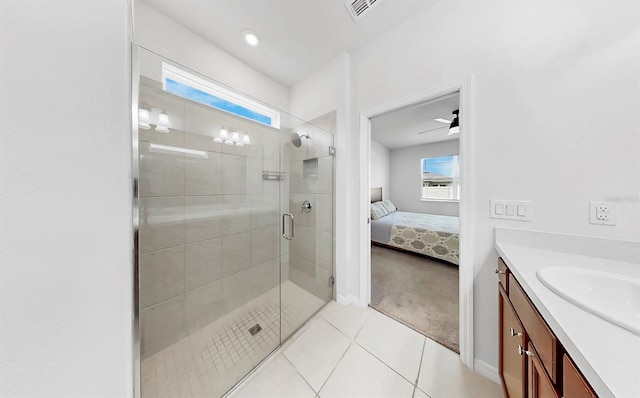 9293 Rally Spring Loop, Wesley Chapel, FL 33545 - ensuite bathroom with vanity, a shower stall, tile patterned floors, and baseboards