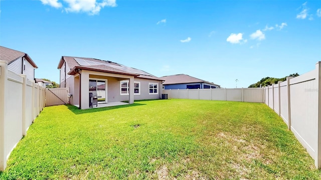 9293 Rally Spring Loop, Wesley Chapel, FL 33545 - back of house featuring roof mounted solar panels, stucco siding, and a patio