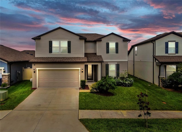 9293 Rally Spring Loop, Wesley Chapel, FL 33545 - traditional home with roof with shingles, an attached garage, concrete driveway, and a lawn