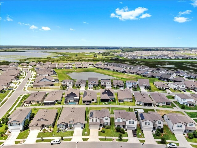 9293 Rally Spring Loop, Wesley Chapel, FL 33545 - aerial perspective of suburban area with a large body of water