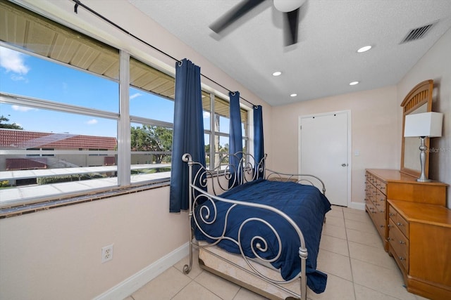 10038 62nd Ter N Unit 17, Saint Petersburg, FL 33708 - bedroom with baseboards, light tile patterned floors, recessed lighting, ceiling fan, and a textured ceiling