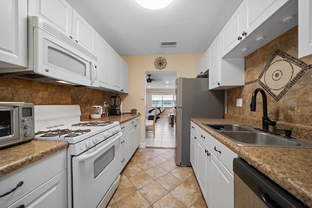 10038 62nd Ter N Unit 17, Saint Petersburg, FL 33708 - kitchen with stainless steel appliances, a sink, and white cabinetry