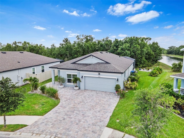 30801 Parrot Reef Ct, Wesley Chapel, FL 33545 - ranch-style home featuring roof with shingles, a garage, stucco siding, a water view, and driveway