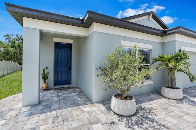30801 Parrot Reef Ct, Wesley Chapel, FL 33545 - entrance to property featuring stucco siding and a garage