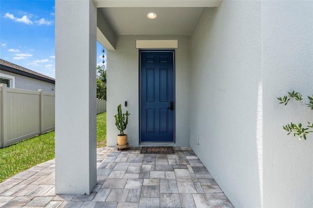 30801 Parrot Reef Ct, Wesley Chapel, FL 33545 - doorway to property with stucco siding