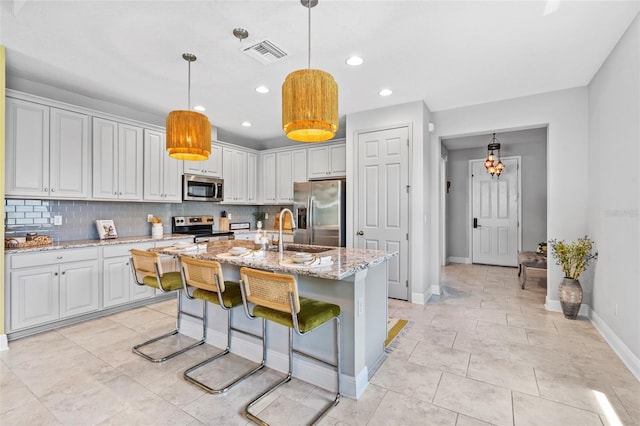 30801 Parrot Reef Ct, Wesley Chapel, FL 33545 - kitchen featuring appliances with stainless steel finishes, a sink, baseboards, tasteful backsplash, and recessed lighting