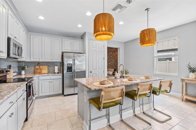 30801 Parrot Reef Ct, Wesley Chapel, FL 33545 - kitchen with stainless steel appliances, a sink, tasteful backsplash, recessed lighting, and light stone countertops
