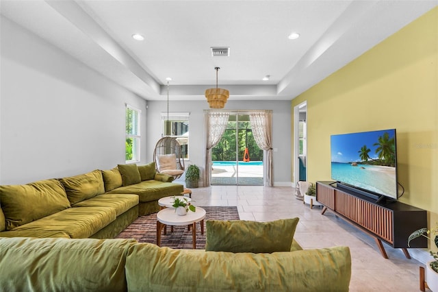 30801 Parrot Reef Ct, Wesley Chapel, FL 33545 - living room featuring a raised ceiling, light tile patterned flooring, recessed lighting, and baseboards