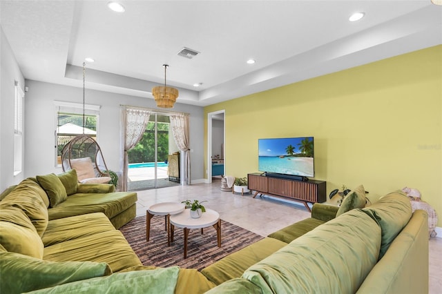 30801 Parrot Reef Ct, Wesley Chapel, FL 33545 - living area featuring a raised ceiling, recessed lighting, baseboards, and tile patterned floors