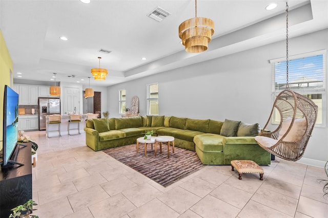 30801 Parrot Reef Ct, Wesley Chapel, FL 33545 - living area with a raised ceiling, recessed lighting, light tile patterned floors, and baseboards
