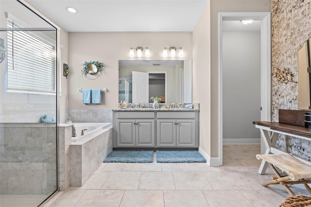 30801 Parrot Reef Ct, Wesley Chapel, FL 33545 - bathroom with vanity, a stall shower, a garden tub, tile patterned floors, and baseboards