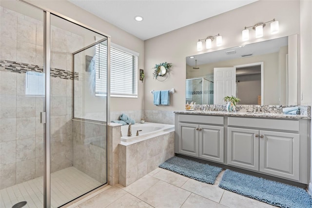 30801 Parrot Reef Ct, Wesley Chapel, FL 33545 - bathroom featuring double vanity, a garden tub, tile patterned floors, and a stall shower