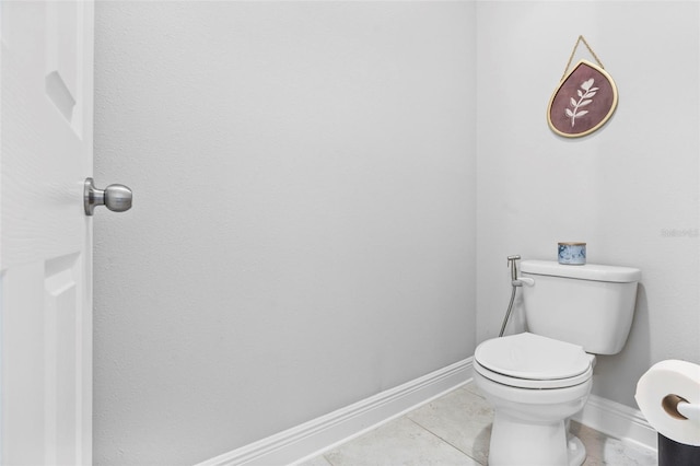 30801 Parrot Reef Ct, Wesley Chapel, FL 33545 - bathroom with baseboards, toilet, and tile patterned flooring