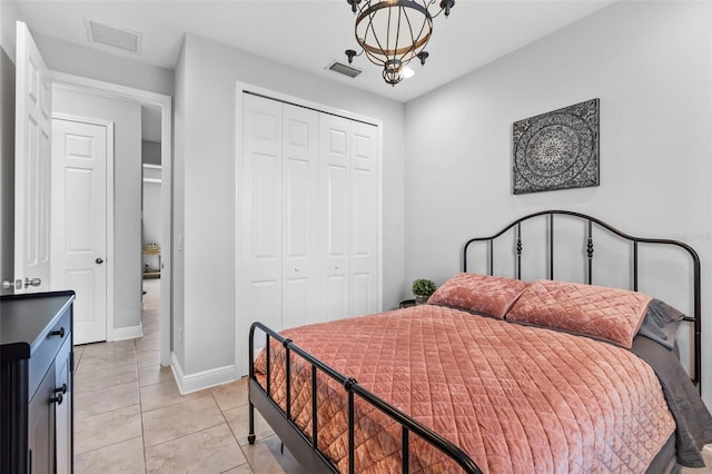 30801 Parrot Reef Ct, Wesley Chapel, FL 33545 - bedroom featuring a closet, light tile patterned flooring, a chandelier, and baseboards